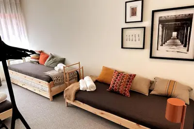 a living room with a couch and pictures on the wall at BOLHÃO - Stylish downtown two bedroom apartment in Porto