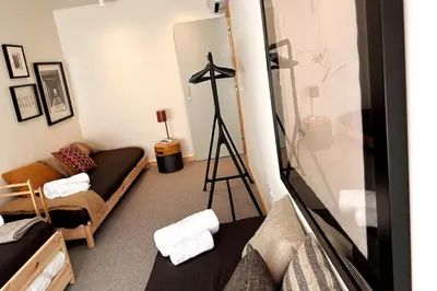 a living room with a couch and a tripod at BOLHÃO - Stylish downtown two bedroom apartment in Porto