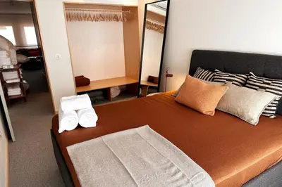 a bedroom with a bed with two towels on it at BOLHÃO - Stylish downtown two bedroom apartment in Porto