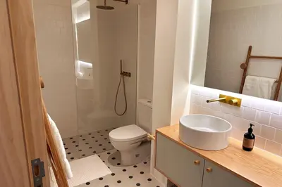 a bathroom with a toilet and a sink and a shower at BOLHÃO - Stylish downtown two bedroom apartment in Porto