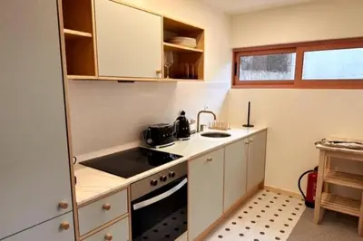 a small kitchen with a sink and a stove at BOLHÃO - Stylish downtown two bedroom apartment in Porto