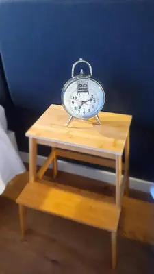 a clock sitting on top of a wooden table at T2P Pilar House in Vila Nova de Gaia