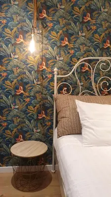 a bedroom with a bed and a blue and gold wallpaper at T2P Pilar House in Vila Nova de Gaia