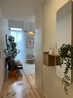 a hallway with a living room with plants in it at Terrace Loft near Porto Center in Porto