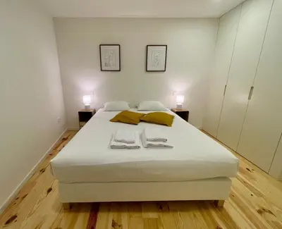 a bedroom with a bed with two towels on it at Terrace Loft near Porto Center in Porto