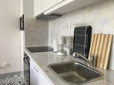 a kitchen counter with a sink and a mixer at City Center Private Parking AC in Porto