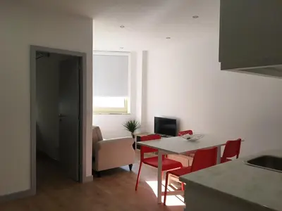 a kitchen and dining room with a table and chairs at City Center Private Parking AC in Porto