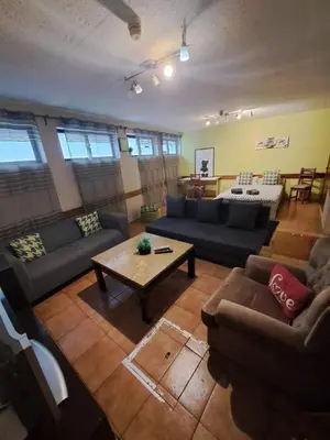 a living room with a bed and a couch at Center Porto Economic Huge Flat in Porto