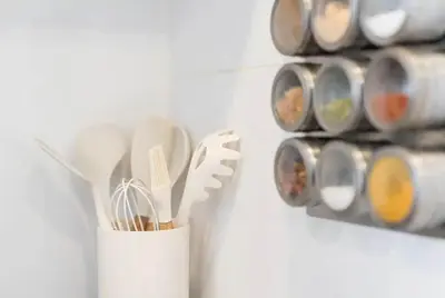a white cup filled with utensils and a rack of paint cans at Art Wine Loft with oPorto view! in Vila Nova de Gaia