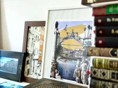 a picture on a desk next to a pile of books at Art Wine Loft with oPorto view! in Vila Nova de Gaia