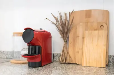 a red coffee maker sitting on a counter next to a cutting board at Art Wine Loft with oPorto view! in Vila Nova de Gaia
