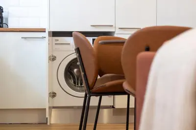 two chairs in a kitchen with a washing machine at Bright 3BR Flat near Douro with AC by LovelyStay in Vila Nova de Gaia