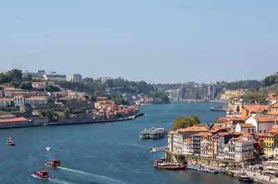a view of a river with buildings and boats at Bright 3BR Flat near Douro with AC by LovelyStay in Vila Nova de Gaia