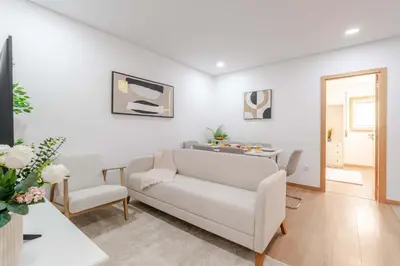a living room with a couch and a chair at Bright & Cozy Apartment by HostWise in Vila Nova de Gaia