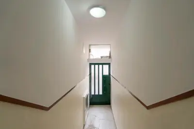 a hallway with a stairway with a door and a window at Bright & Cozy Apartment by HostWise in Vila Nova de Gaia