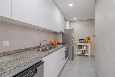 a kitchen with a sink and a counter top at Bright & Cozy Apartment by HostWise in Vila Nova de Gaia