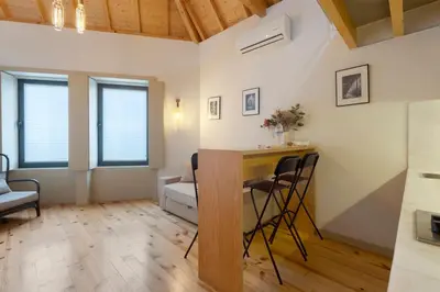 a bedroom with a bed in a room with wooden ceilings at Orange Apartments B in Porto