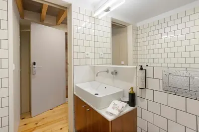 a bathroom with a urinal in a tiled room at Orange Apartments B in Porto