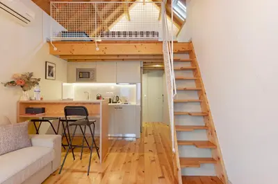 a living room with a couch and a loft bed at Orange Apartments B in Porto
