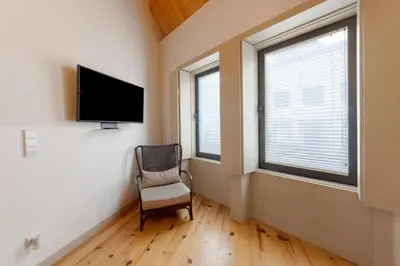 a living room with a couch and two windows at Orange Apartments B in Porto