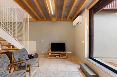 a living room with a bed and a table and chairs at Orange Apartments A in Porto
