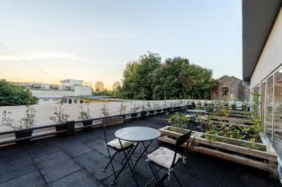 a patio with a table and chairs on a balcony at Bom Sucesso Executive Suites by HostWise in Porto