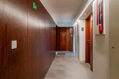 a hallway with wooden walls and a hallway with a door at Bom Sucesso Executive Suites by HostWise in Porto