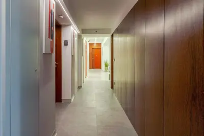 a hallway with wooden walls and a long hallway at Bom Sucesso Executive Suites by HostWise in Porto