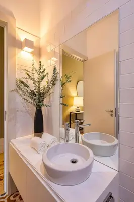 a bathroom with a sink and a toilet and a shower at Almada Relax in Porto