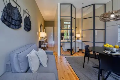 a kitchen and dining room with a table and chairs at Almada Relax in Porto