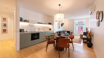 a kitchen and dining room with a table and chairs at Ando Living - São Miguel House in Porto