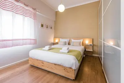 a bedroom with a large bed with two towels on it at GuestReady Essential - Heartbeats in Porto