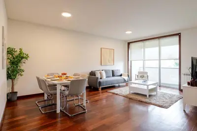 a living room with a table and a couch at Modern & Spacious Flat with Garage by HostWise in Vila Nova de Gaia