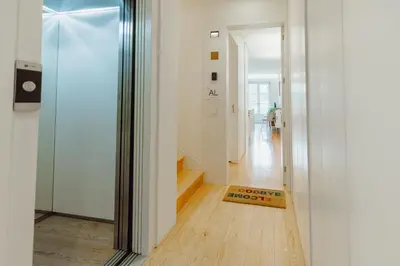 a hallway with a glass door leading into a home at Historical Taipas Apartments by Vacationy in Porto