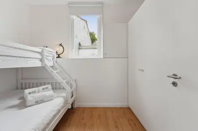 a white room with a bunk bed and a window at GuestReady - Enjoy Comfort in Porto in Porto