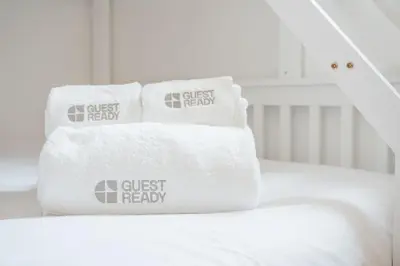 a stack of towels sitting on top of a bed at GuestReady - Enjoy Comfort in Porto in Porto