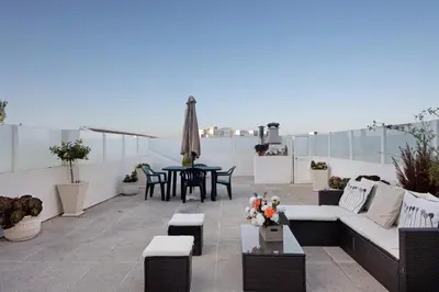 a patio with couches and a table on a roof at Douro Garden Home Rooftop in Vila Nova de Gaia