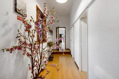 a hallway with a vase with flowers on the wall at Douro Garden House and Pool in Vila Nova de Gaia