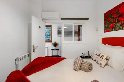 a bedroom with a large bed with a red blanket at Douro Garden House and Pool in Vila Nova de Gaia