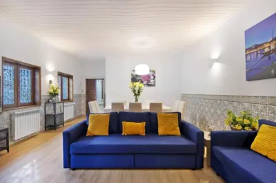 a living room with blue couches and a table at Douro Garden House and Pool in Vila Nova de Gaia