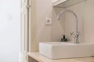 a bathroom with a sink and a shower and a toilet at Liiiving in Porto - Design Palace Studio in Porto