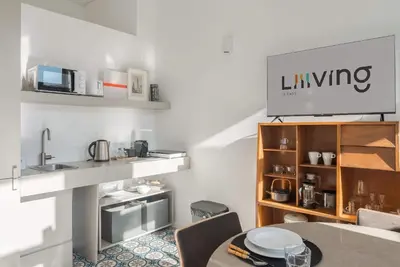 a kitchen with a sink and a microwave at Liiiving in Porto - Design Palace Studio in Porto
