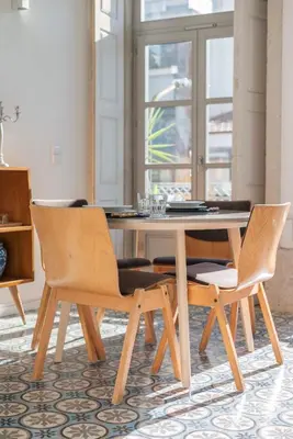 a dining room with a table and a large window at Liiiving in Porto - Design Palace Studio in Porto
