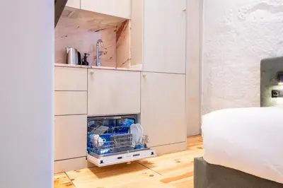 a small kitchen with a dishwasher in a cabinet at Bainharia 82 by LovelyStay in Porto