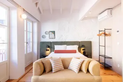 a bedroom with a bed and a couch at Bainharia 82 by LovelyStay in Porto