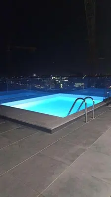 a blue swimming pool at night with a city at New Douro Tower 203 With Parking in Vila Nova de Gaia