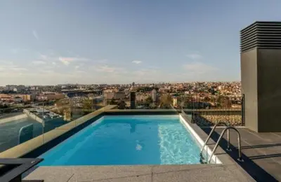 a swimming pool on top of a building at New Douro Tower 203 With Parking in Vila Nova de Gaia