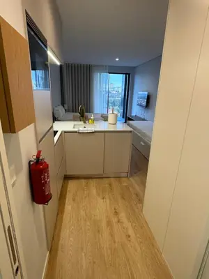 a small kitchen with a sink and a tub at New Douro Tower 203 With Parking in Vila Nova de Gaia