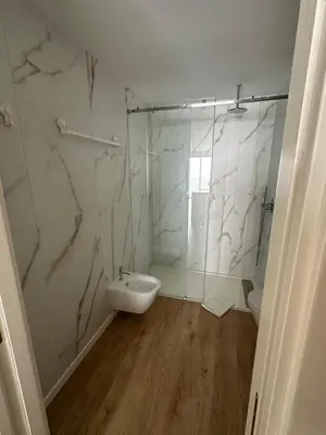 a bathroom with a shower and a sink and a toilet at New Douro Tower 305 with shared pool and parking in Vila Nova de Gaia