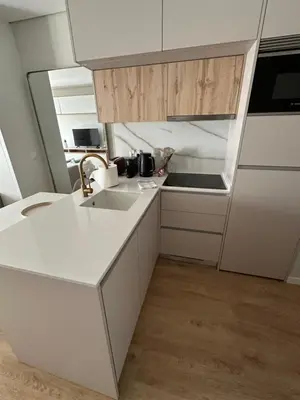 a white kitchen with a sink and a stove at New Douro Tower 206 with shared pool and parking in Vila Nova de Gaia